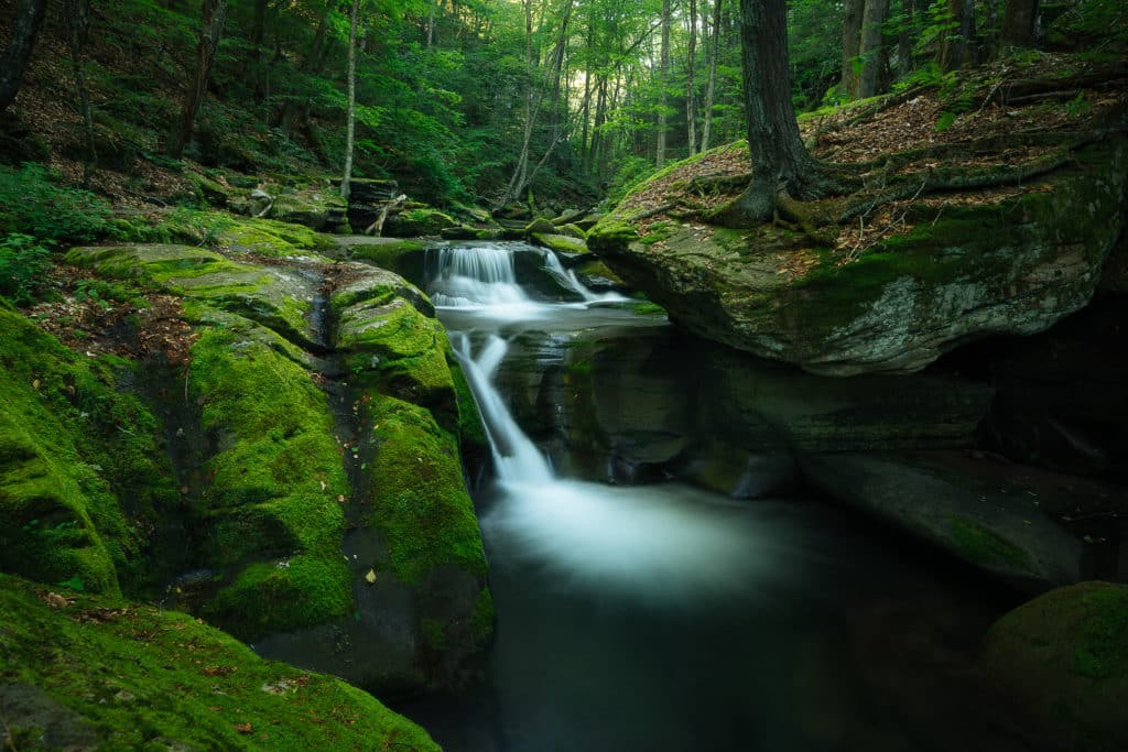 Serene pool with waterfall in the Catskill mountains