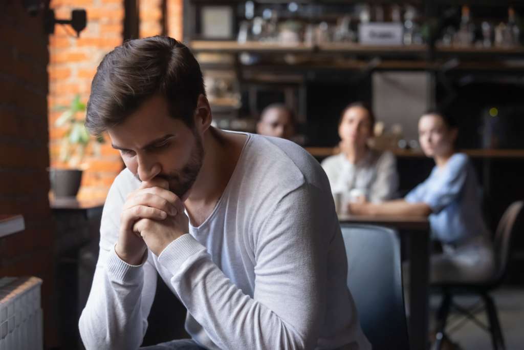 Young man prays to ask Jesus into his life