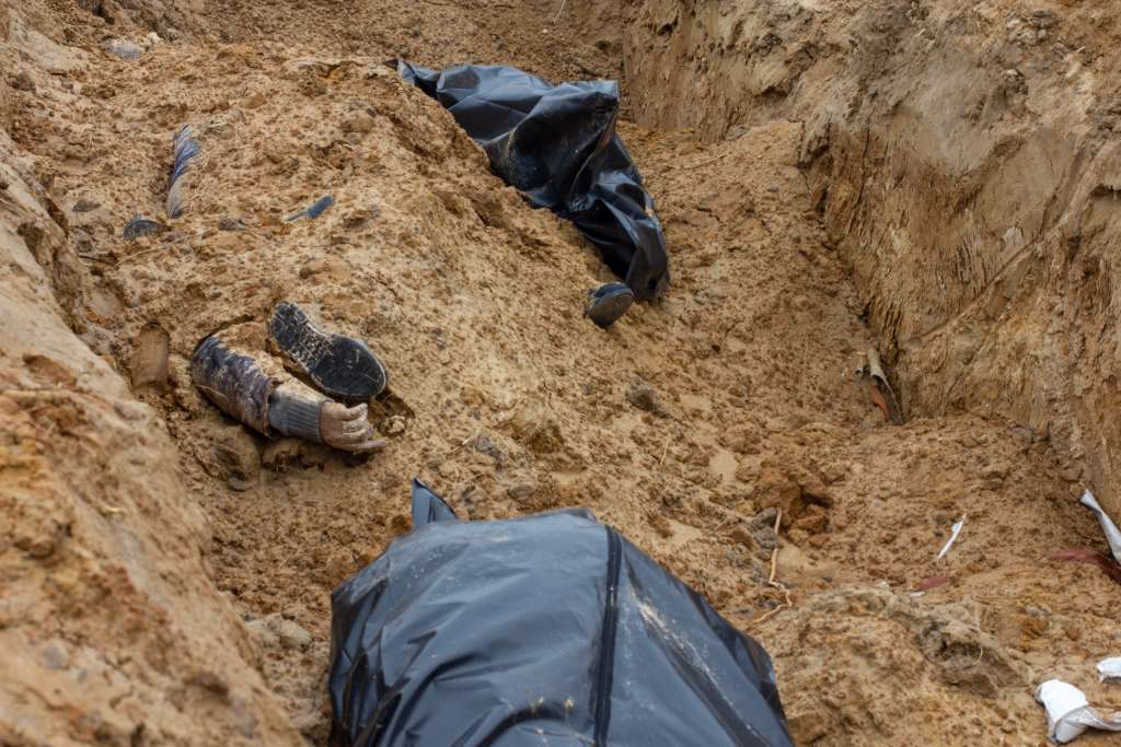синий-lamborghini.  Bodies of Ukrainian civilians lay ina ditch.